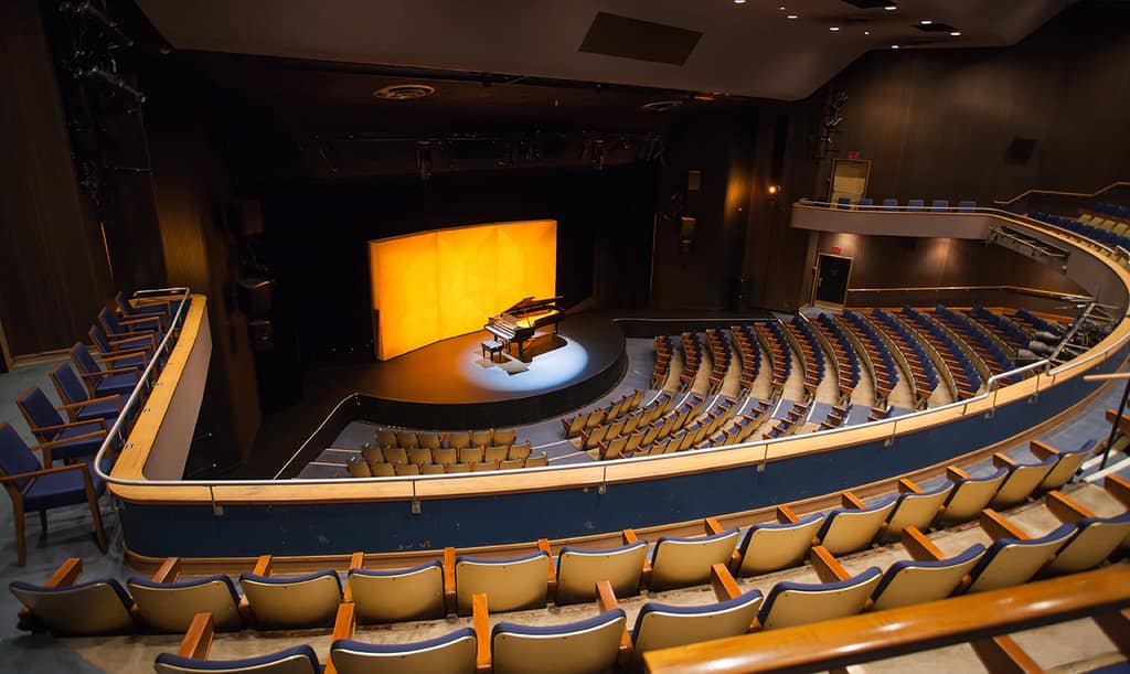 A grand piano lit on the Vancouver Playhouse stage